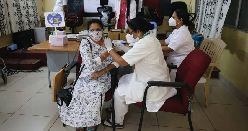 A health executive the COVAXIN vaccine for COVID-19 to a woman at a government hospital in Bengaluru.